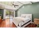 Beautiful bedroom featuring hardwood floors, a ceiling fan, and access to an outdoor space at 3906 Twin Rivers Trl, Parrish, FL 34219