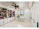 Bonus room with custom built-in shelving, a ceiling fan, and a large window at 3906 Twin Rivers Trl, Parrish, FL 34219