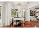 Bright breakfast nook featuring hardwood floors, a marble table, and views of the screened-in outdoor living area at 3906 Twin Rivers Trl, Parrish, FL 34219