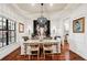Elegant dining room with rustic wood table, modern chandelier, and sophisticated decor accents at 3906 Twin Rivers Trl, Parrish, FL 34219