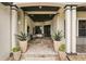 Inviting home entrance with decorative potted plants, stylish tiled floors, and elegant architectural features at 3906 Twin Rivers Trl, Parrish, FL 34219