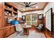Executive home office with custom wood paneling, built-in shelving, and stylish decor at 3906 Twin Rivers Trl, Parrish, FL 34219
