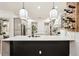 Spacious kitchen with a large island, stylish pendant lighting, and convenient wine storage at 3906 Twin Rivers Trl, Parrish, FL 34219