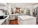 Open-concept kitchen with an island, stainless steel appliances, and a view of the living area at 3906 Twin Rivers Trl, Parrish, FL 34219