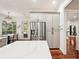Bright kitchen with modern stainless steel refrigerator, neutral cabinets, and access to outdoor living at 3906 Twin Rivers Trl, Parrish, FL 34219