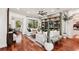 Bright and airy living room featuring hardwood floors, comfortable seating, and stylish built-in shelving at 3906 Twin Rivers Trl, Parrish, FL 34219