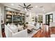 Bright and airy living room featuring hardwood floors, comfortable seating, and stylish built-in shelving at 3906 Twin Rivers Trl, Parrish, FL 34219