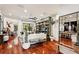 Bright and airy living room featuring hardwood floors, comfortable seating, and stylish built-in shelving at 3906 Twin Rivers Trl, Parrish, FL 34219