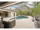 Enjoy the outdoors year-round with this screened-in pool and lanai, complete with a spa and palm trees at 3906 Twin Rivers Trl, Parrish, FL 34219