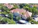 Aerial view of property highlighting the lush landscaping and neighborhood amenities including a pool and water feature at 4140 Central Sarasota Pkwy # 1235, Sarasota, FL 34238