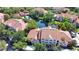 Scenic aerial showcasing community buildings, pond, pool, and verdant surrounding landscape at 4140 Central Sarasota Pkwy # 1235, Sarasota, FL 34238