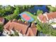 Aerial view of community featuring a tennis court, red tile roofs, and verdant landscaping at 4140 Central Sarasota Pkwy # 1235, Sarasota, FL 34238