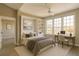 Staged bedroom with a built-in bookcase and a work area by the bright window at 4140 Central Sarasota Pkwy # 1235, Sarasota, FL 34238