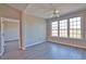 A bright, empty bedroom with wood-look floors and a large window is ready for you at 4140 Central Sarasota Pkwy # 1235, Sarasota, FL 34238