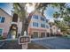Attractive condo building with garages and inviting exterior features and verdant trees at 4140 Central Sarasota Pkwy # 1235, Sarasota, FL 34238