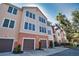 Exterior shot of condo buildings with attached garages, and well-maintained landscaping at 4140 Central Sarasota Pkwy # 1235, Sarasota, FL 34238