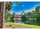 Community clubhouse overlooking the water and surrounded by lush landscaping at 4140 Central Sarasota Pkwy # 1235, Sarasota, FL 34238