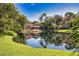 Community clubhouse overlooking the water and surrounded by lush landscaping at 4140 Central Sarasota Pkwy # 1235, Sarasota, FL 34238