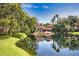 Community clubhouse overlooking the water and surrounded by lush landscaping at 4140 Central Sarasota Pkwy # 1235, Sarasota, FL 34238