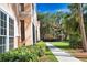 Beautiful multi-story building with lush landscaping, sidewalk, and green grass at 4140 Central Sarasota Pkwy # 1235, Sarasota, FL 34238