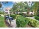 Well-maintained community grilling area with picnic table, mature trees and lush green landscape at 4140 Central Sarasota Pkwy # 1235, Sarasota, FL 34238