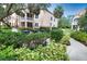 Community outdoor grilling area with multiple grills, manicured landscaping, and a nearby walkway at 4140 Central Sarasota Pkwy # 1235, Sarasota, FL 34238