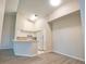 Bright kitchen features white cabinetry, neutral countertops, and essential appliances, seamlessly connecting to the living area at 4140 Central Sarasota Pkwy # 1235, Sarasota, FL 34238