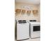 Modern laundry room equipped with a washer and dryer and storage shelves at 4140 Central Sarasota Pkwy # 1235, Sarasota, FL 34238