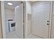 Bright laundry room features a washer, dryer, and shelving for convenient storage at 4140 Central Sarasota Pkwy # 1235, Sarasota, FL 34238