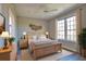 Cozy bedroom with a ceiling fan, natural light, and stylish decor at 4140 Central Sarasota Pkwy # 1235, Sarasota, FL 34238