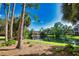 Scenic pond view highlighting lush greenery and serene reflections of the nearby community buildings at 4140 Central Sarasota Pkwy # 1235, Sarasota, FL 34238