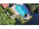 Aerial view of a pristine pool surrounded by palm trees and a cozy spa area at 4140 Central Sarasota Pkwy # 1235, Sarasota, FL 34238