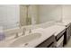 Bathroom featuring double sinks, quartz countertops, and modern fixtures at 4267 Expedition Way, Osprey, FL 34229