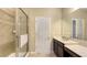 Bright bathroom featuring a glass enclosed shower and a vanity with a long mirror at 4267 Expedition Way, Osprey, FL 34229