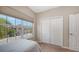 A bedroom with a large window and closet provides ample space and natural light at 4267 Expedition Way, Osprey, FL 34229