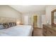 Cozy bedroom showcasing a dresser, a plush bed, and neutral wall colors at 4267 Expedition Way, Osprey, FL 34229