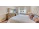Bedroom with a stylish bed, a wooden dresser, and a bright window at 4267 Expedition Way, Osprey, FL 34229