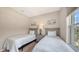 Cozy bedroom featuring twin beds with a neutral palette and plenty of natural light at 4267 Expedition Way, Osprey, FL 34229