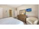 Relaxing bedroom with a comfy bed, a wooden dresser, and access to the ensuite bathroom at 4267 Expedition Way, Osprey, FL 34229