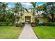 Inviting building entrance with well-maintained landscaping and a brick walkway at 4267 Expedition Way, Osprey, FL 34229