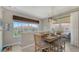 Bright dining area featuring a large window, wood table with seating, and view of the neighborhood at 4267 Expedition Way, Osprey, FL 34229