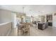 Open-concept dining area with tile flooring, stylish light fixture, and sliding glass doors to a balcony at 4267 Expedition Way, Osprey, FL 34229