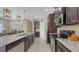 Modern kitchen featuring granite countertops, stainless steel appliances, and dark wood cabinetry at 4267 Expedition Way, Osprey, FL 34229