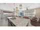 Open kitchen with granite counters, stainless steel appliances, pendant lighting, and seamless living space at 4267 Expedition Way, Osprey, FL 34229