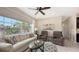 Inviting living room with cozy seating, a glass coffee table, and a scenic outdoor view at 4267 Expedition Way, Osprey, FL 34229