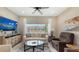 Bright living room with a large window, comfortable seating, and stylish decor at 4267 Expedition Way, Osprey, FL 34229