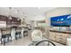 Open concept living space with a kitchen bar, dining area, and a cozy living area at 4267 Expedition Way, Osprey, FL 34229