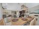 Spacious living space featuring dining table, stainless steel appliances, and comfortable furniture at 4267 Expedition Way, Osprey, FL 34229