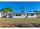 The house has a spacious backyard with a patio area and is surrounded by lush greenery and new metal roof at 4505 18Th W Ave, Bradenton, FL 34209