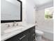 Bathroom featuring a vanity with a marble countertop, drawers, a decorative backsplash, and a shower-tub combo at 4505 18Th W Ave, Bradenton, FL 34209